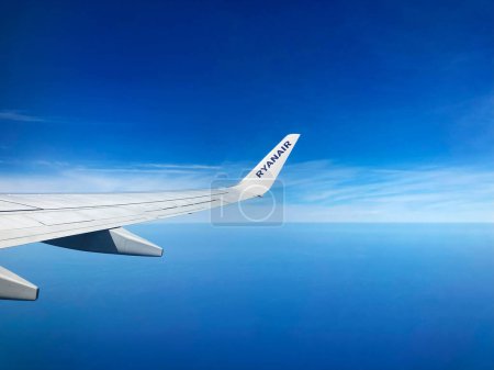 Photo for Italy, Palermo - April 08, 2024: wing of Ryanair airline aircraft in background of blue sky and sea - Royalty Free Image