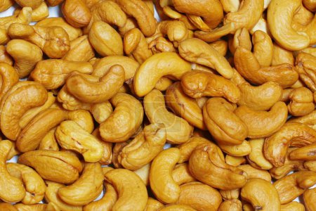 Photo of lots of cashew nuts on a white background
