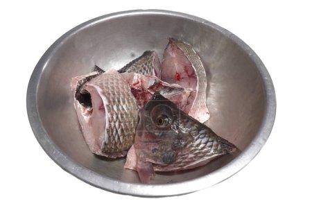 Photo for White background photo Tilapia is chopped into pieces in a stainless steel bowl to prepare for cooking. - Royalty Free Image