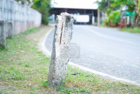 Photo for Broken roadside barrier with rebar visible inside - Royalty Free Image