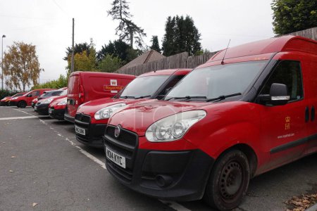 Photo for Royal Mail delivery vans sit parked near a post office sorting depo on October 16, 2022 in Marlborough, UK. Royal Mail workers are calling for industrial action and strikes in demanding a pay rise. - Royalty Free Image