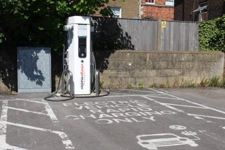 Photo for An electric vehicle rapid charging station is seen on a town centre street on July 9, 2022 in Trowbridge, UK. Electric vehicle supply equipment is becoming ubiquitous across the British Isles. - Royalty Free Image