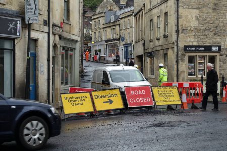 Photo for Bradford on Avon, UK - March 12, 2018: Road workers repairing road surface at roadworks in town centre. - Royalty Free Image