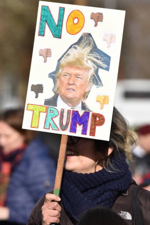 Photo for Protesters hold up placards while rallying against Donald Trump and his upcoming state visit to Britain on February 4, 2017 in Bristol, UK. The US President is invited to visit the United Kingdom. - Royalty Free Image