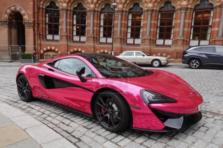 Photo for A metallic pink Mclaren 540C Coupe S-A V8 VVT Twin Turbo SSG supercar is seen parked on a city centre street on July 31, 2023 in London, UK. - Royalty Free Image