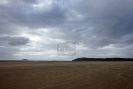 Photo for Scenic view of a spacious windswept Brean beach on the coast of the Bristol Channel and Atlantic ocean in southwest England - Royalty Free Image
