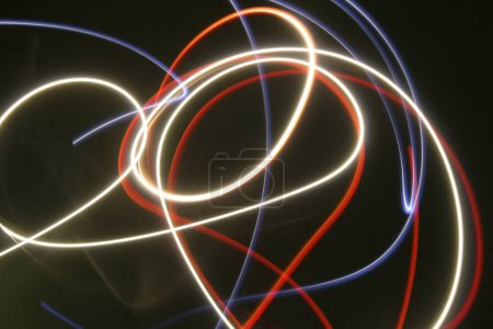 Abstract colorful irregular lines on black / green background photo with long exposure . Light painting photography. Lights with irregular patterns for overlay