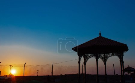 Photo for Silhouette image of the beautiful arch during sunrise and golden sky or blue sky in the background in Gandikota Grand Canyon of India tourism place located at Kadapa, Andhra pradesh - Royalty Free Image