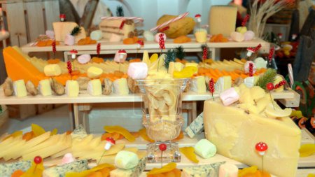 An assortment of delicious local and imported cheese at a restaurant lunch buffet service.