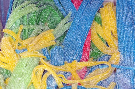 A closeup shot of an assortment of colorful sour candy.