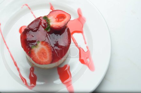 A beautiful over head shot for a delicious strawberry cheesecake dessert.