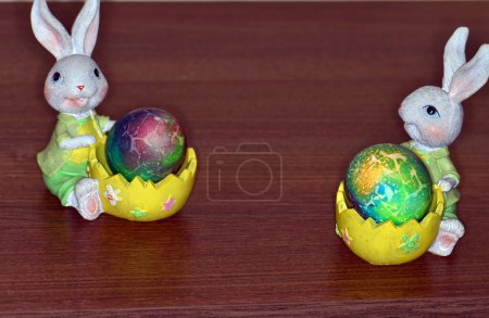 Photo for Two rabbit egg holder ornament isolated on a wooden background. - Royalty Free Image