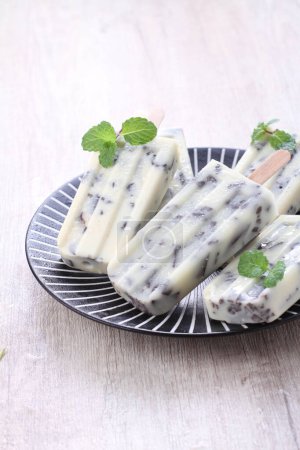 Photo for Homemade ice cream with mint and green leaves - Royalty Free Image