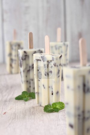 Photo for Ice cream with mint and chocolate on wooden background - Royalty Free Image