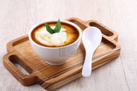 Photo for Bowl of tasty creamy soup with fresh parsley on wooden background - Royalty Free Image
