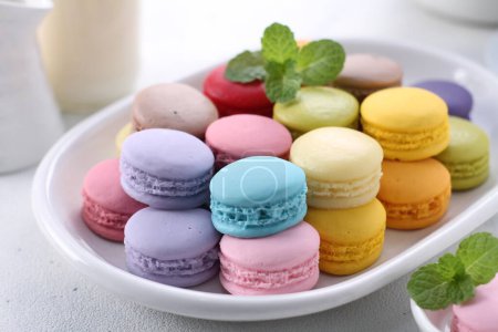Photo for Colorful macaroons on a plate on a white background - Royalty Free Image