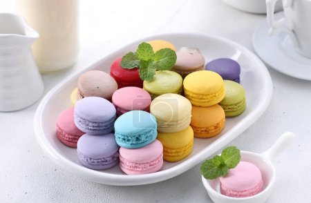 Photo for Colorful macaroons with mint leaves on white background - Royalty Free Image
