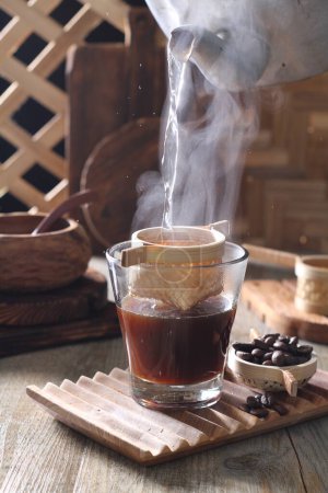 Photo for Hot coffee with a cup of tea and a glass of milk on a wooden background - Royalty Free Image