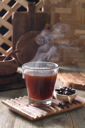 Photo for Hot coffee with cinnamon and anise on wooden background - Royalty Free Image
