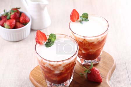 Photo for Delicious strawberry smoothie with fresh berries on wooden table - Royalty Free Image