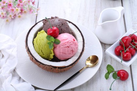 Photo for Ice cream with strawberries and mint on a white plate - Royalty Free Image
