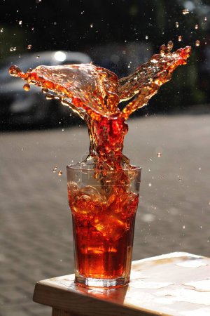 Photo for Cola pouring into glass with ice cubes - Royalty Free Image