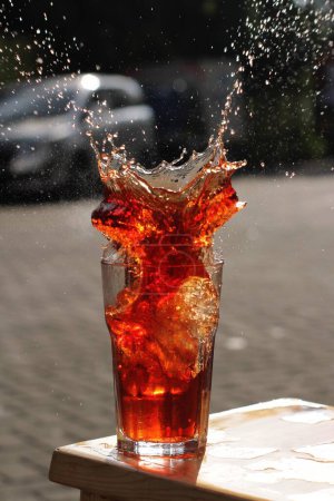 Photo for Pouring water into a glass with ice cubes - Royalty Free Image