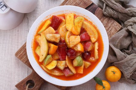 Photo for Asinan is a pickled vegetable or fruit dish, commonly found in Indonesia. Asin, Indonesian for "salty", is the process of preserving the ingredients by soaking them in a solution of salty water. Asinan is quite similar to rujak', - Royalty Free Image