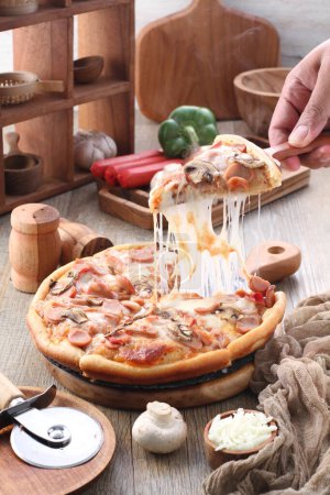 Photo for Pizza is a dish of Italian origin consisting of a usually round, flat base of leavened wheat-based dough topped with tomatoes, cheese, and often various other ingredients - Royalty Free Image