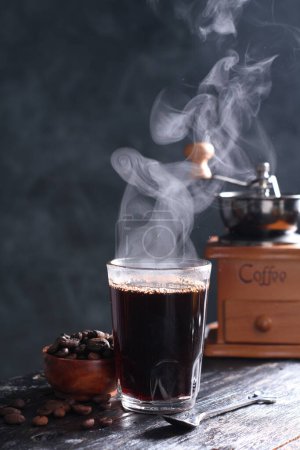 Photo for Kopi Tubruk is an Indonesian-style coffee where hot water is poured over fine coffee grounds directly in the glass, without any filtration, usually with added sugar. - Royalty Free Image