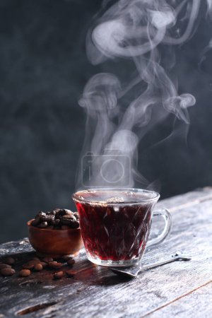 Photo for Kopi Tubruk is an Indonesian-style coffee where hot water is poured over fine coffee grounds directly in the glass, without any filtration, usually with added sugar. In Bali, Kopi Tubruk is known by the name "Kopi Selem" which means black coffee. - Royalty Free Image