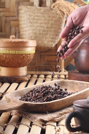 Téléchargez les photos : Grains de café dans un bol en bois sur un fond de vieux bois - en image libre de droit