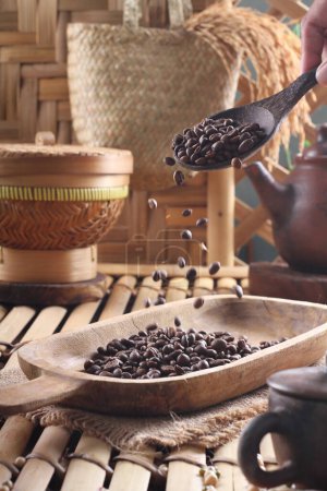 Photo for Coffee beans in a wooden bowl on a background of old wood - Royalty Free Image