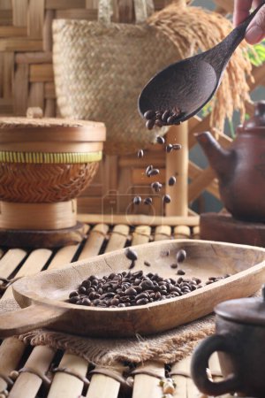 Photo for Coffee beans in a wooden bowl on a background of old wood - Royalty Free Image
