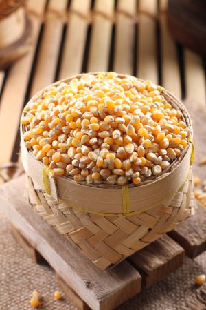 Photo for Yellow corn in a wooden bowl on the table - Royalty Free Image