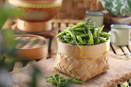 Photo for Fresh green peas in basket on wooden table - Royalty Free Image