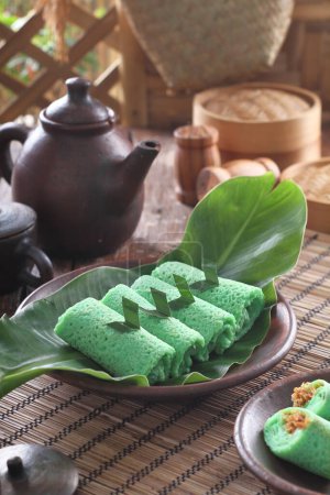 Photo for Dadar gulung (lit:"rolled pancake/omelette") is a popular traditional kue (traditional snack) of sweet coconut pancake. It is often described as an Indonesian coconut pancake Dadar gulung is one of the popular snacks in Indonesia, especially in Java. - Royalty Free Image