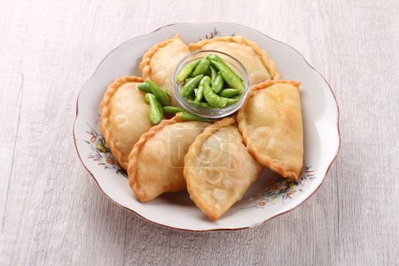 Photo for Jalangkote (Lontara: ) is a South Sulawesi fried dumpling from Indonesian cuisine, stuffed with rice vermicelli, vegetables, potatoes and eggs. Spicy, sweet and sour sauce will be dipped into prior to be eaten. - Royalty Free Image