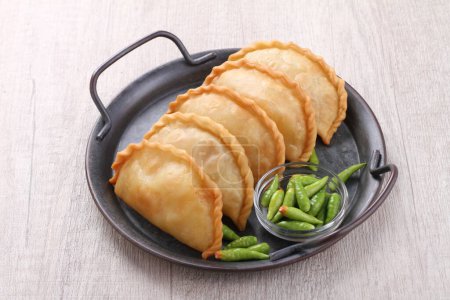 Photo for Jalangkote (Lontara: ) is a South Sulawesi fried dumpling from Indonesian cuisine, stuffed with rice vermicelli, vegetables, potatoes and eggs. Spicy, sweet and sour sauce will be dipped into prior to be eaten. - Royalty Free Image