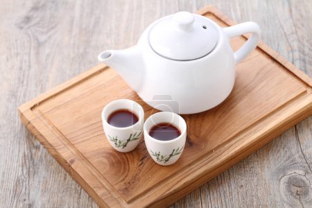 Photo for Tea is an aromatic beverage prepared by pouring hot or boiling water over cured or fresh leaves of Camellia sinensis, an evergreen shrub native to East Asia which probably originated in the borderlands - Royalty Free Image