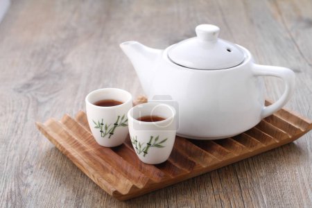 Photo for Tea is an aromatic beverage prepared by pouring hot or boiling water over cured or fresh leaves of Camellia sinensis, an evergreen shrub native to East Asia which probably originated in the borderlands - Royalty Free Image