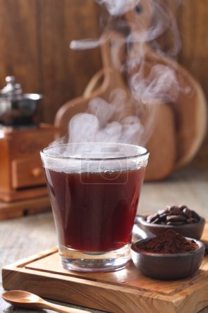 Photo for Coffee is a drink prepared from roasted coffee beans. Darkly colored, bitter, and slightly acidic, coffee has a stimulating effect on humans, primarily due to its caffeine content. It has the highest sales in the world market for hot drinks. - Royalty Free Image