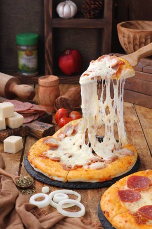 Photo for Pizza is a dish of Italian origin consisting of a usually round, flat base of leavened wheat-based dough topped with tomatoes, cheese, and often various other ingredients - Royalty Free Image