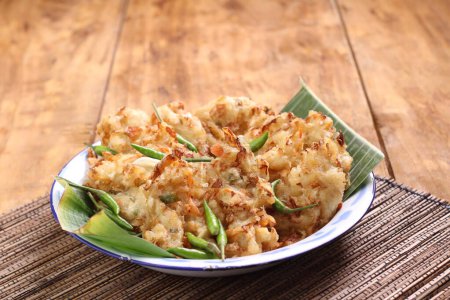 Photo for Bakwan is a fried food made from vegetables and wheat flour that is commonly found in Indonesia. Bakwan usually refers to fried snacks of vegetables that are usually sold by traveling hawkers. - Royalty Free Image