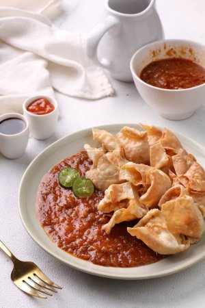 Photo for Batagor  is a Sundanese dish from Indonesia, and popular in Southeast Asia, consisting of fried fish dumplings, usually served with peanut sauce. It is traditionally made from minced tenggiri, - Royalty Free Image