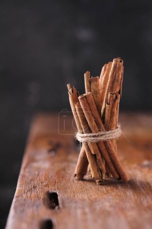 Photo for Cinnamon on the wooden table - Royalty Free Image
