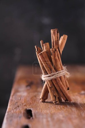Photo for Cinnamon on the wooden table - Royalty Free Image