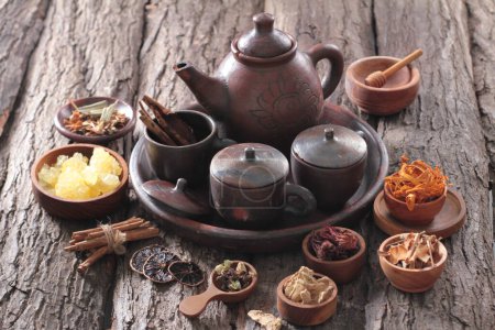 Photo for Some types of herbs circling the teapot - Royalty Free Image