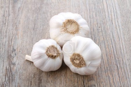 Photo for Garlic on a wooden cutting board close-up - Royalty Free Image
