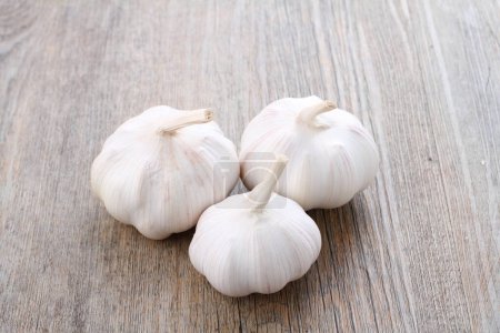 Photo for Garlic on wooden cutting background - Royalty Free Image